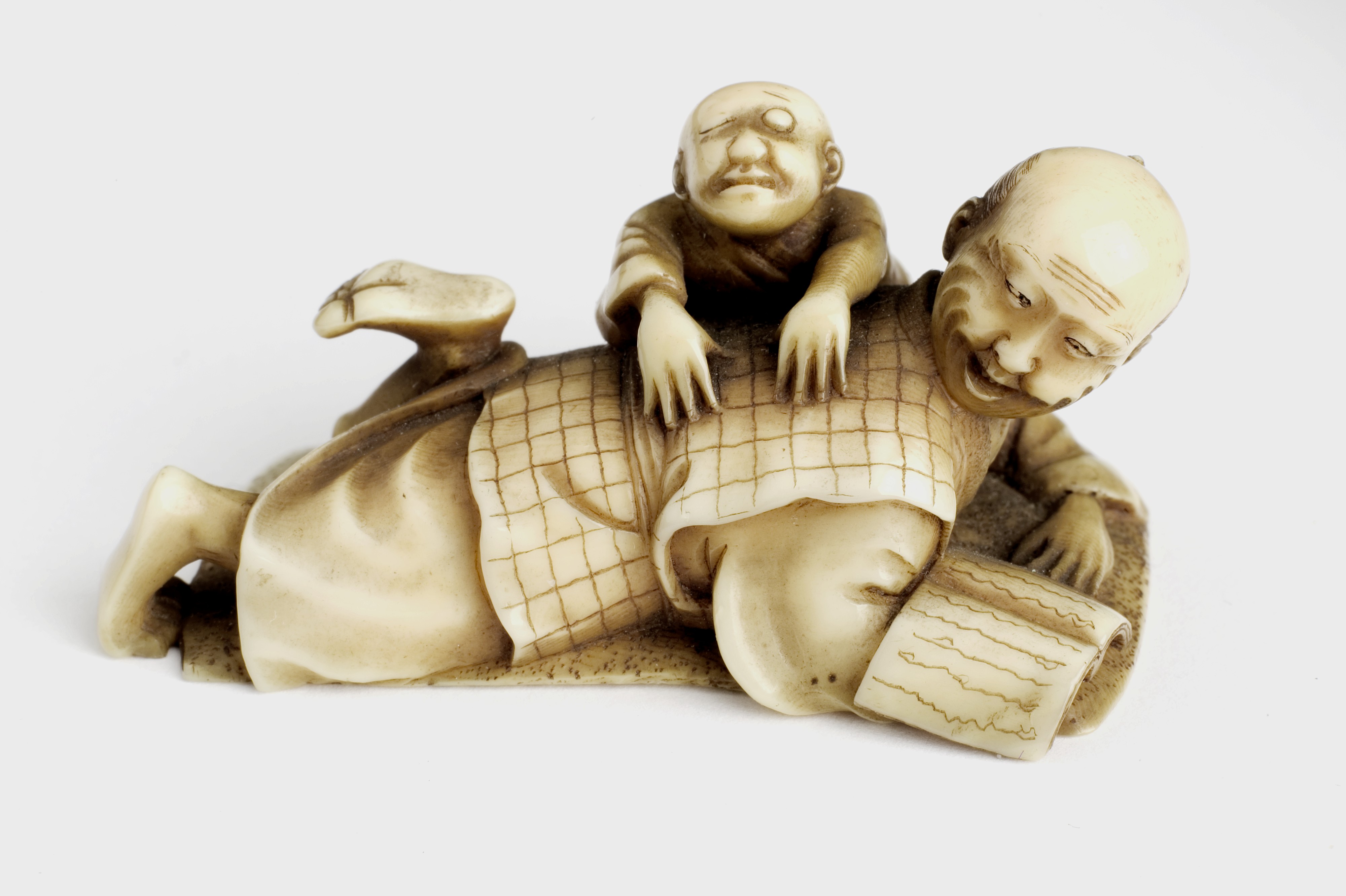 L0058581 Ivory figure of man massaging the back of another man. Japan